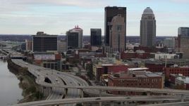5.7K aerial stock footage ascend over freeway with view of skyscrapers in Downtown Louisville, Kentucky Aerial Stock Footage | DX0001_003024