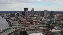 5.7K aerial stock footage fly away from the city's skyline beside a freeway in Downtown Louisville, Kentucky Aerial Stock Footage | DX0001_003028