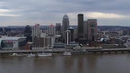 5.7K aerial stock footage of flying by the city skyline beside the river in Downtown Louisville, Kentucky Aerial Stock Footage | DX0001_003042