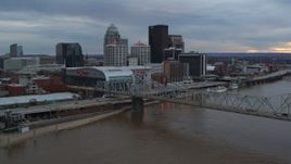 5.7K aerial stock footage of arena and city skyline seen from bridge spanning river at sunset, Downtown Louisville, Kentucky Aerial Stock Footage | DX0001_003065