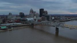 5.7K aerial stock footage fly over the river to approach arena and city skyline at sunset, Downtown Louisville, Kentucky Aerial Stock Footage | DX0001_003076