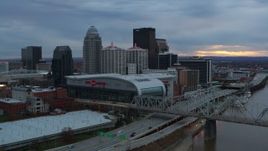 5.7K aerial stock footage flyby river and bridge to pass arena and city skyline at sunset, Downtown Louisville, Kentucky Aerial Stock Footage | DX0001_003077