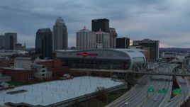 5.7K aerial stock footage descend by freeway with view of arena and city skyline at sunset, Downtown Louisville, Kentucky Aerial Stock Footage | DX0001_003078