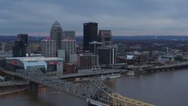 5.7K aerial stock footage reverse view of city skyline at sunset while ascending by the bridge, Downtown Louisville, Kentucky Aerial Stock Footage | DX0001_003081