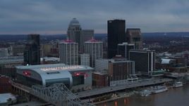 5.7K aerial stock footage fly away from arena and city skyline at sunset, reveal river, Downtown Louisville, Kentucky Aerial Stock Footage | DX0001_003084