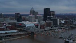 5.7K aerial stock footage of the arena and city skyline at sunset, seen from near the bridge, Downtown Louisville, Kentucky Aerial Stock Footage | DX0001_003085