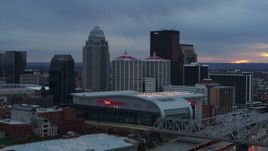 5.7K aerial stock footage flyby arena and city skyline at sunset, seen while passing bridge, Downtown Louisville, Kentucky Aerial Stock Footage | DX0001_003086