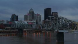 5.7K aerial stock footage flyby bridge over the river at sunset toward arena, skyline in background, Downtown Louisville, Kentucky Aerial Stock Footage | DX0001_003090