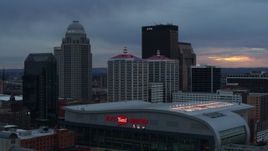 5.7K aerial stock footage descend by arena at sunset and focus on the skyline, Downtown Louisville, Kentucky Aerial Stock Footage | DX0001_003092