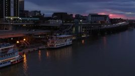 5.7K aerial stock footage approach and orbit small riverboat at twilight in Downtown Louisville, Kentucky Aerial Stock Footage | DX0001_003094