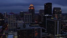 5.7K aerial stock footage of flying by hotel, with the skyline lit up at twilight, Downtown Louisville, Kentucky Aerial Stock Footage | DX0001_003100