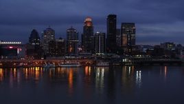 5.7K aerial stock footage of the skyline lit up at twilight across the Ohio River, Downtown Louisville, Kentucky Aerial Stock Footage | DX0001_003102