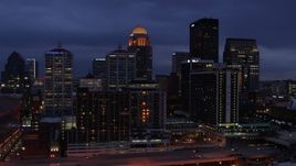 5.7K aerial stock footage fly over Ohio River toward the hotel and skyline lit up at twilight, Downtown Louisville, Kentucky Aerial Stock Footage | DX0001_003105