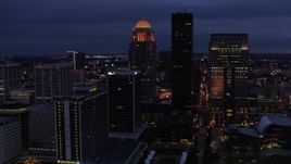 5.7K aerial stock footage reverse view of a tall skyscraper and skyline lit up at twilight, Downtown Louisville, Kentucky Aerial Stock Footage | DX0001_003107