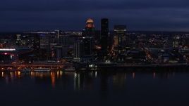 5.7K aerial stock footage slowly pass the city's skyline at twilight, seen from across Ohio River, Downtown Louisville, Kentucky Aerial Stock Footage | DX0001_003109