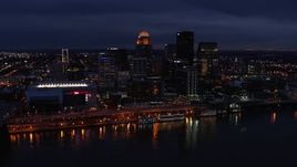 5.7K aerial stock footage slowly fly away from and by the city's skyline at twilight, seen from Ohio River, Downtown Louisville, Kentucky Aerial Stock Footage | DX0001_003111