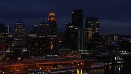 5.7K aerial stock footage reverse view of hotel and the city skyline at twilight, reveal river, Downtown Louisville, Kentucky Aerial Stock Footage | DX0001_003115