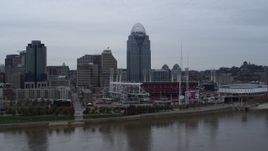 5.7K aerial stock footage ascend over river for a view of the baseball stadium and skyscraper, Downtown Cincinnati, Ohio Aerial Stock Footage | DX0001_003124