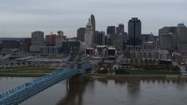 5.7K aerial stock footage slow pass over bridge and river with view of city skyline, Downtown Cincinnati, Ohio Aerial Stock Footage | DX0001_003130