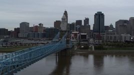 5.7K aerial stock footage ascend by Roebling Bridge to approach the city's skyline, Downtown Cincinnati, Ohio Aerial Stock Footage | DX0001_003134