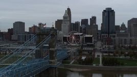 5.7K aerial stock footage descend by bridge to reveal river while focused on the city skyline, Downtown Cincinnati, Ohio Aerial Stock Footage | DX0001_003138