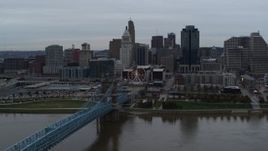 5.7K aerial stock footage of the Roebling Bridge and city skyline seen from the Ohio River, Downtown Cincinnati, Ohio Aerial Stock Footage | DX0001_003140