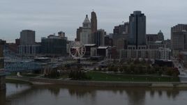5.7K aerial stock footage fly over Ohio River to approach Ferris wheel and skyline, Downtown Cincinnati, Ohio Aerial Stock Footage | DX0001_003141