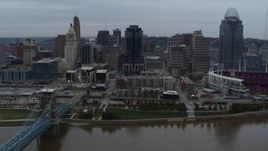 5.7K aerial stock footage slow pass by city skyline, seen from the Ohio River near bridge, Downtown Cincinnati, Ohio Aerial Stock Footage | DX0001_003145
