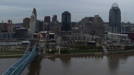 5.7K aerial stock footage descend toward the river by bridge while focused on skyline, Downtown Cincinnati, Ohio Aerial Stock Footage | DX0001_003149