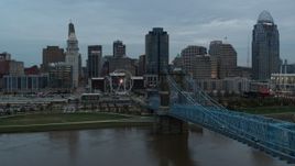 5.7K aerial stock footage follow bridge over the river toward the city skyline at sunset, Downtown Cincinnati, Ohio Aerial Stock Footage | DX0001_003151