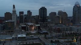 5.7K aerial stock footage flying by the Ferris wheel and city skyline at sunset, Downtown Cincinnati, Ohio Aerial Stock Footage | DX0001_003155