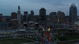 5.7K aerial stock footage ascend by Roebling Bridge for reverse view of Ferris wheel and city skyline at sunset, Downtown Cincinnati, Ohio Aerial Stock Footage | DX0001_003158