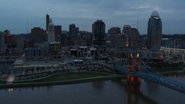 5.7K aerial stock footage passing the city skyline at sunset, seen from Ohio River, Downtown Cincinnati, Ohio Aerial Stock Footage | DX0001_003159