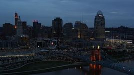 5.7K aerial stock footage ascend over Ohio River at twilight with view of bridge and skyline, Downtown Cincinnati, Ohio Aerial Stock Footage | DX0001_003163