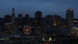 5.7K aerial stock footage reverse view of city skyline and Ferris wheel lit up at twilight, reveal bridge and Ohio River, Downtown Cincinnati, Ohio Aerial Stock Footage | DX0001_003168