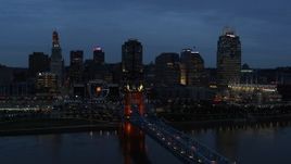 5.7K aerial stock footage of city skyline and Roebling Bridge lit up at twilight, seen from Ohio River, Downtown Cincinnati, Ohio Aerial Stock Footage | DX0001_003169
