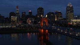 5.7K aerial stock footage ascend from river by bridge to approach city skyline at twilight, Downtown Cincinnati, Ohio Aerial Stock Footage | DX0001_003181