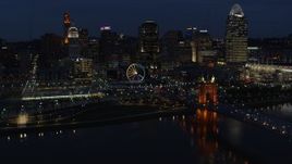 5.7K aerial stock footage flying by the city skyline at twilight, seen from river near bridge, Downtown Cincinnati, Ohio Aerial Stock Footage | DX0001_003187