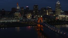 5.7K aerial stock footage descend by the bridge with a view of the skyline across the river at twilight, Downtown Cincinnati, Ohio Aerial Stock Footage | DX0001_003188