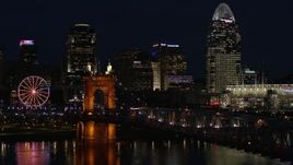 5.7K aerial stock footage fly over Roebling Bridge at night to approach city skyline, Downtown Cincinnati, Ohio Aerial Stock Footage | DX0001_003191