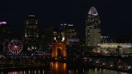 5.7K aerial stock footage descend and pass bridge, tall skyscrapers and Ferris wheel at night in Downtown Cincinnati, Ohio Aerial Stock Footage | DX0001_003194