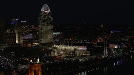 5.7K aerial stock footage of a tall skyscraper and the baseball stadium at night in Downtown Cincinnati, Ohio Aerial Stock Footage | DX0001_003195