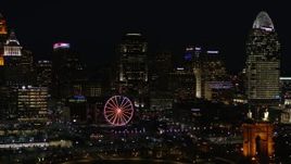 5.7K aerial stock footage ascend with a view of the city skyline and Ferris wheel at night, Downtown Cincinnati, Ohio Aerial Stock Footage | DX0001_003197