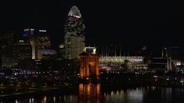 5.7K aerial stock footage orbit Roebling Bridge at night with city skyline in background, Downtown Cincinnati, Ohio Aerial Stock Footage | DX0001_003199