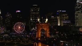 5.7K aerial stock footage close orbit of Roebling Bridge at night, reveal city skyline in background, Downtown Cincinnati, Ohio Aerial Stock Footage | DX0001_003200