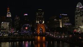 5.7K aerial stock footage descend by Roebling Bridge at night with city skyline in background, Downtown Cincinnati, Ohio Aerial Stock Footage | DX0001_003201