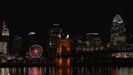 5.7K aerial stock footage of the Roebling Bridge at night with city skyline in background, Downtown Cincinnati, Ohio Aerial Stock Footage | DX0001_003202