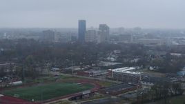 5.7K aerial stock footage reverse view of the city skyline seen from residential neighborhoods, Downtown Lexington, Kentucky Aerial Stock Footage | DX0001_003207
