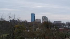 5.7K aerial stock footage ascend from trees to reveal city's skyline, Downtown Lexington, Kentucky Aerial Stock Footage | DX0001_003210