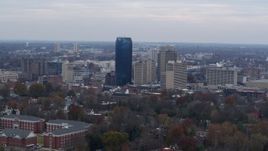 5.7K aerial stock footage slowly passing the city's skyline, seen from tree-lined neighborhoods, Downtown Lexington, Kentucky Aerial Stock Footage | DX0001_003213